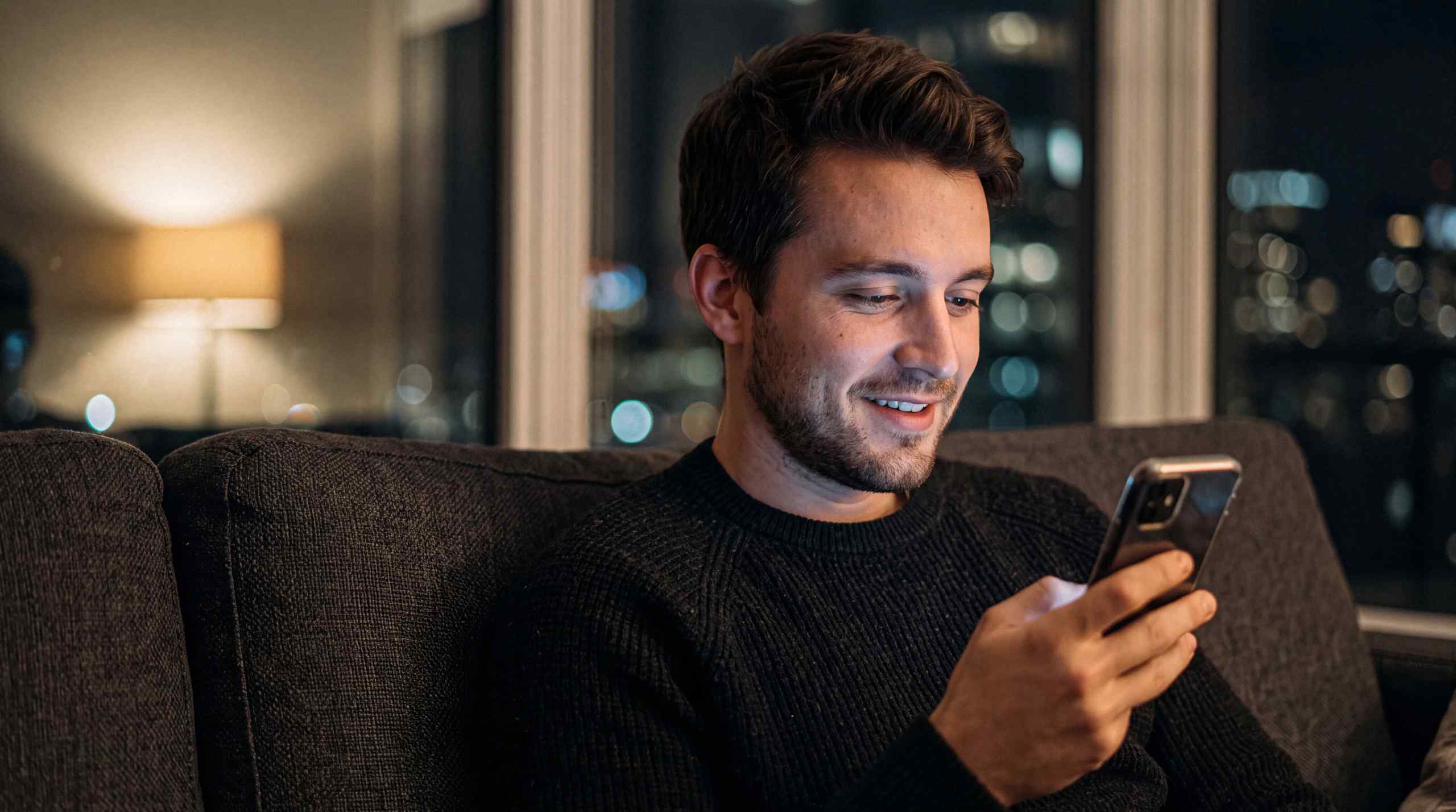 A man playing a sweeps casino app on his phone.